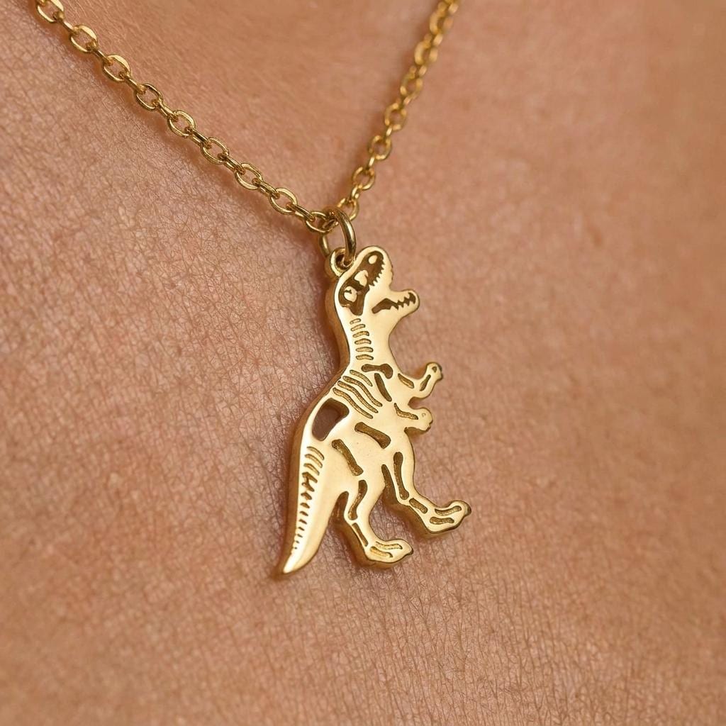 Small gold T-rex skeleton pendant in profile on a fine cable chain. (2 of 10)