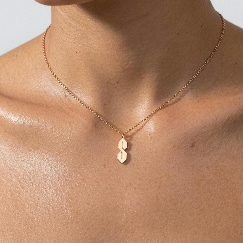 Fine gold chain necklace with an angular geometric S shaped pendant