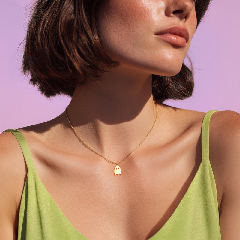 Tiny gold ghost pendant on a fine cable chain, shown flat (3 of 8)