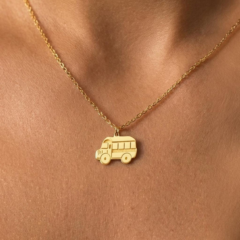 Small school bus pendant on a delicate gold chain necklace