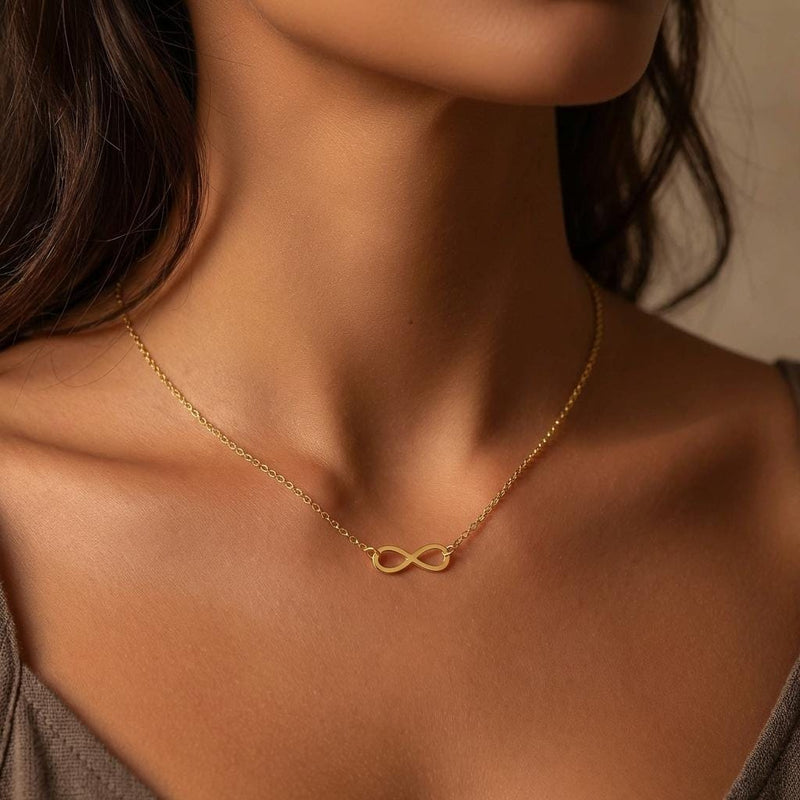 Small gold infinity loop pendant lying flat on a fine cable chain (5 of 10)