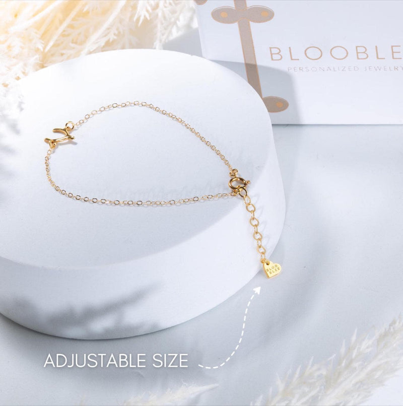 Fine chain bracelet with a small flat gold infinity loop charm at the center. (5 of 6)