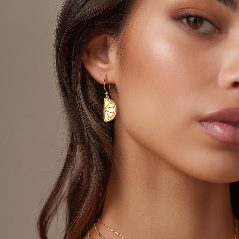 Pair of small gold lemon stud earrings with a tiny leaf at the stem. (2 of 6)