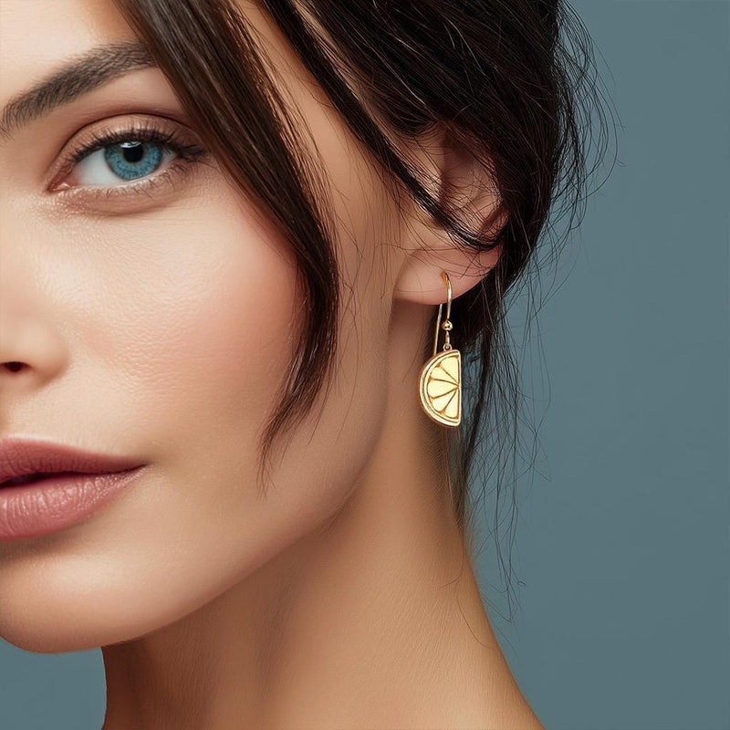 Pair of small gold lemon stud earrings with a tiny leaf at the stem. (3 of 6)