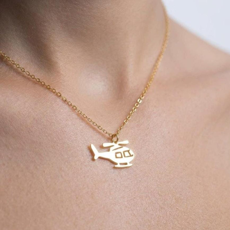 Small helicopter pendant in profile on a fine gold cable chain