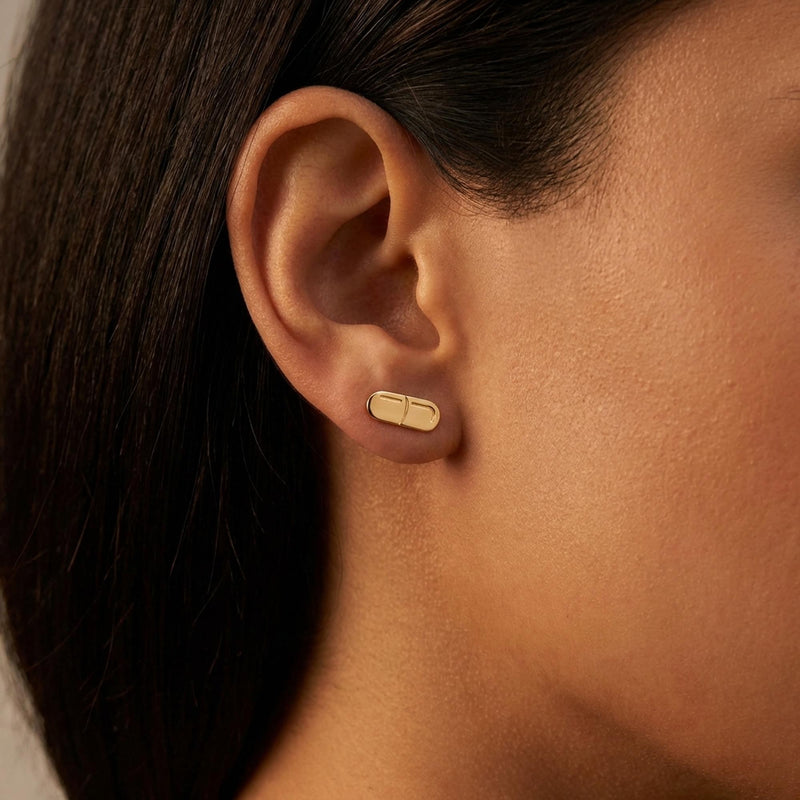 Pair of narrow gold capsule pill stud earrings with a seam across the middle (4 of 10)