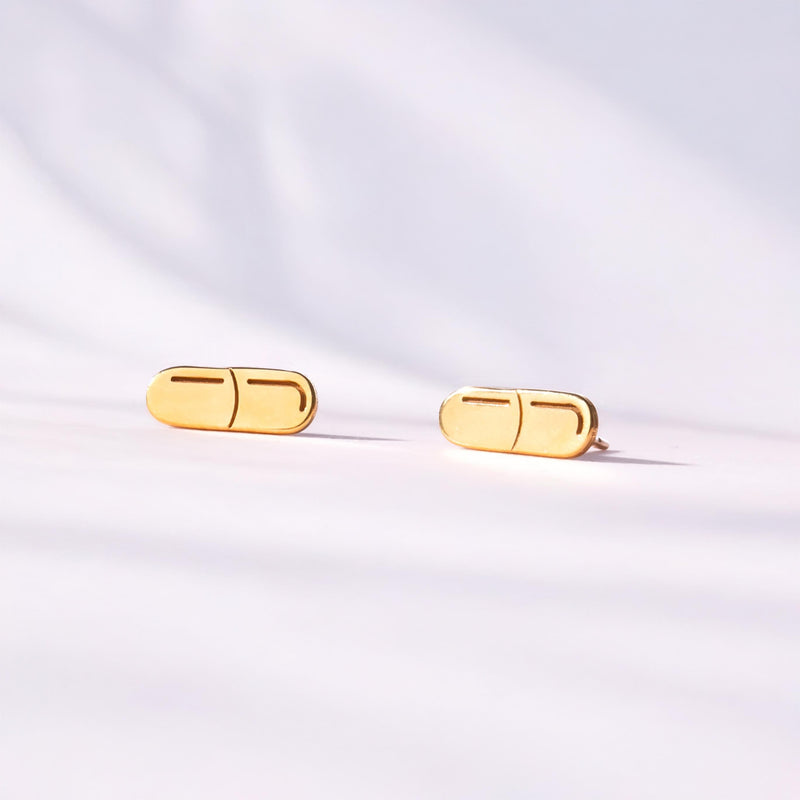 Pair of narrow gold capsule pill stud earrings with a seam across the middle (6 of 10)