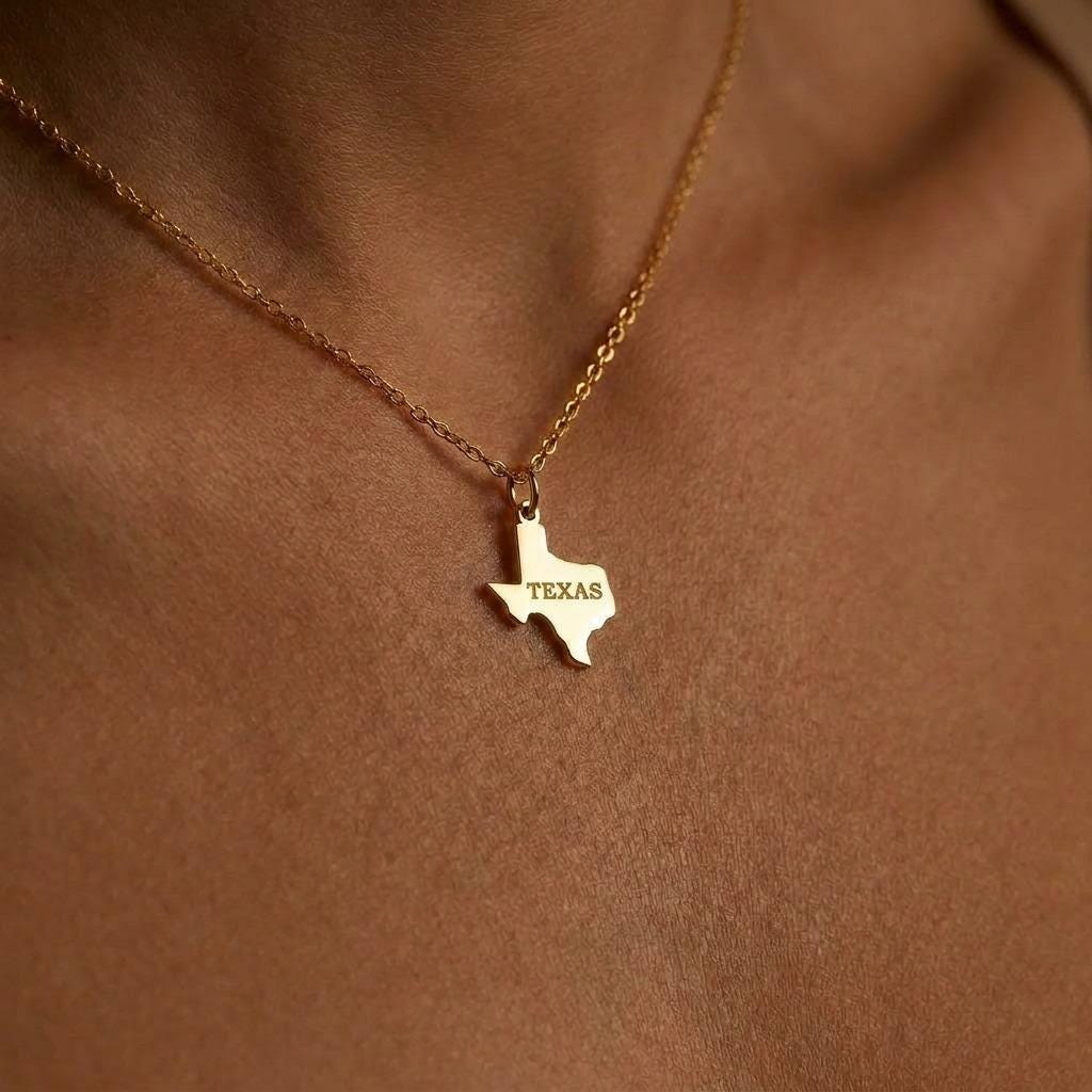 Small Texas state outline pendant on a thin gold cable chain