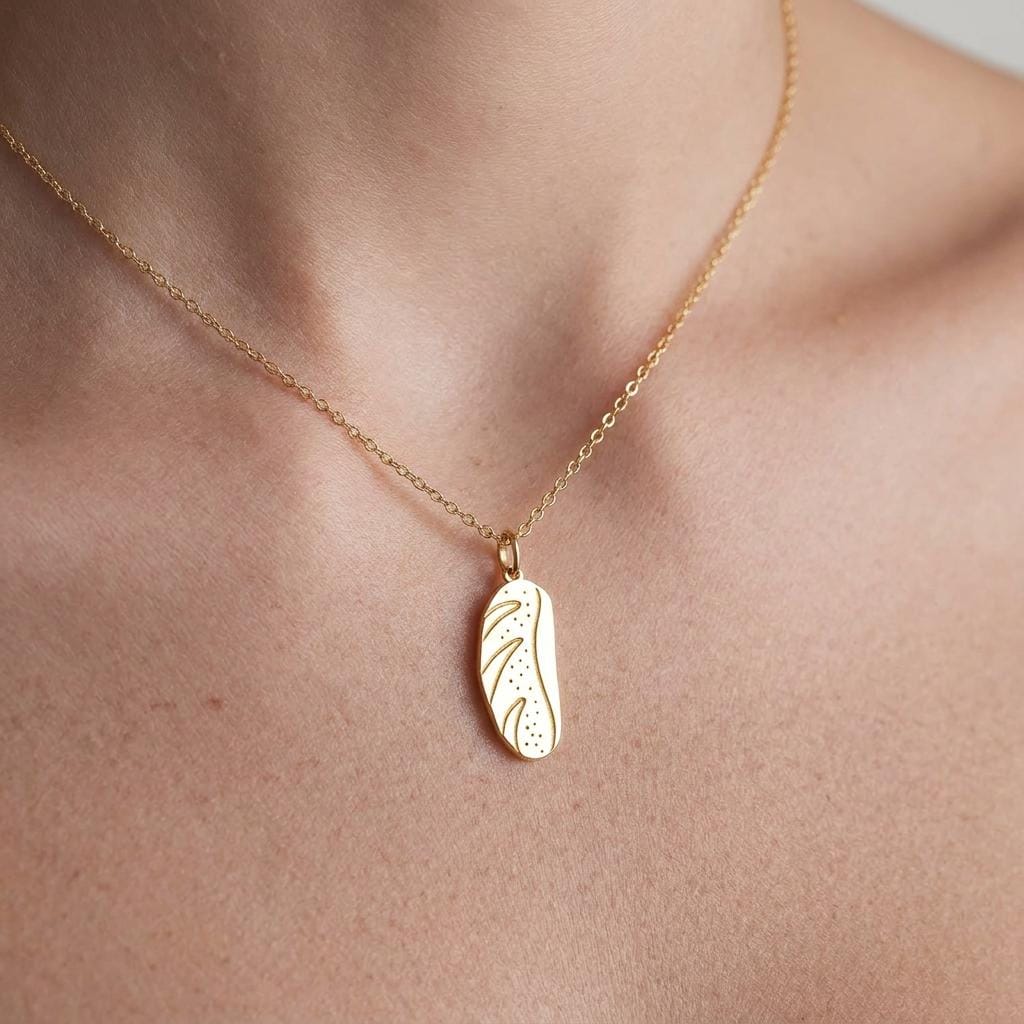 Small gold bread loaf pendant on a fine cable chain necklace