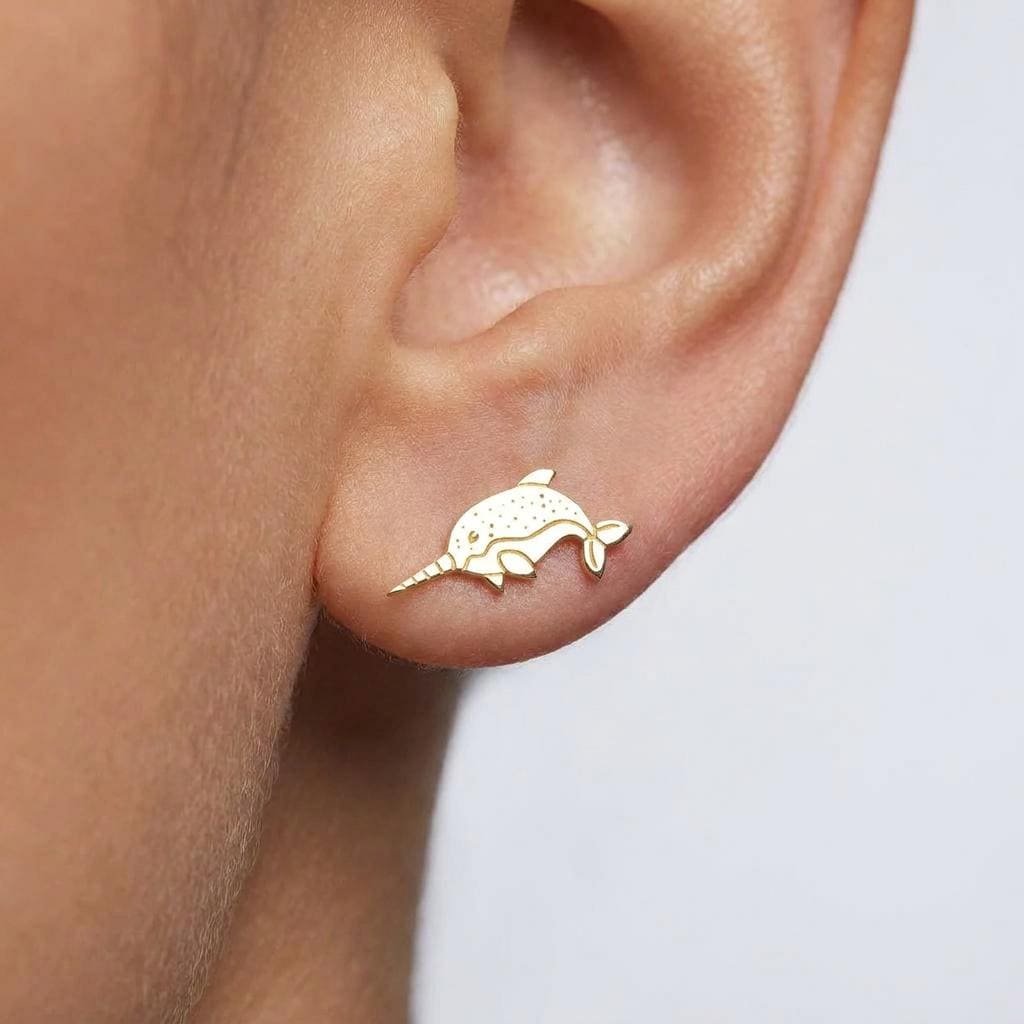 Pair of gold narwhal stud earrings with long spiral tusks