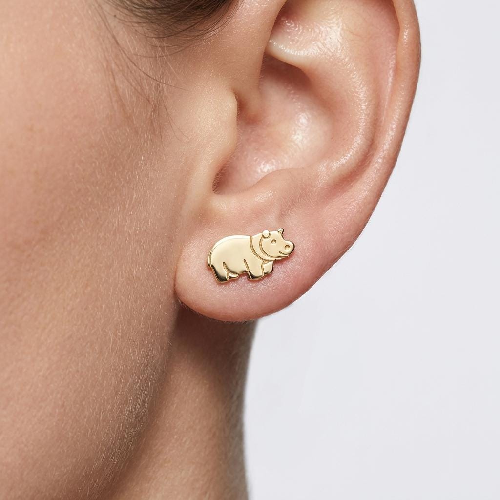 Pair of tiny gold hippo stud earrings shown in profile with a broad snout (2 of 9)