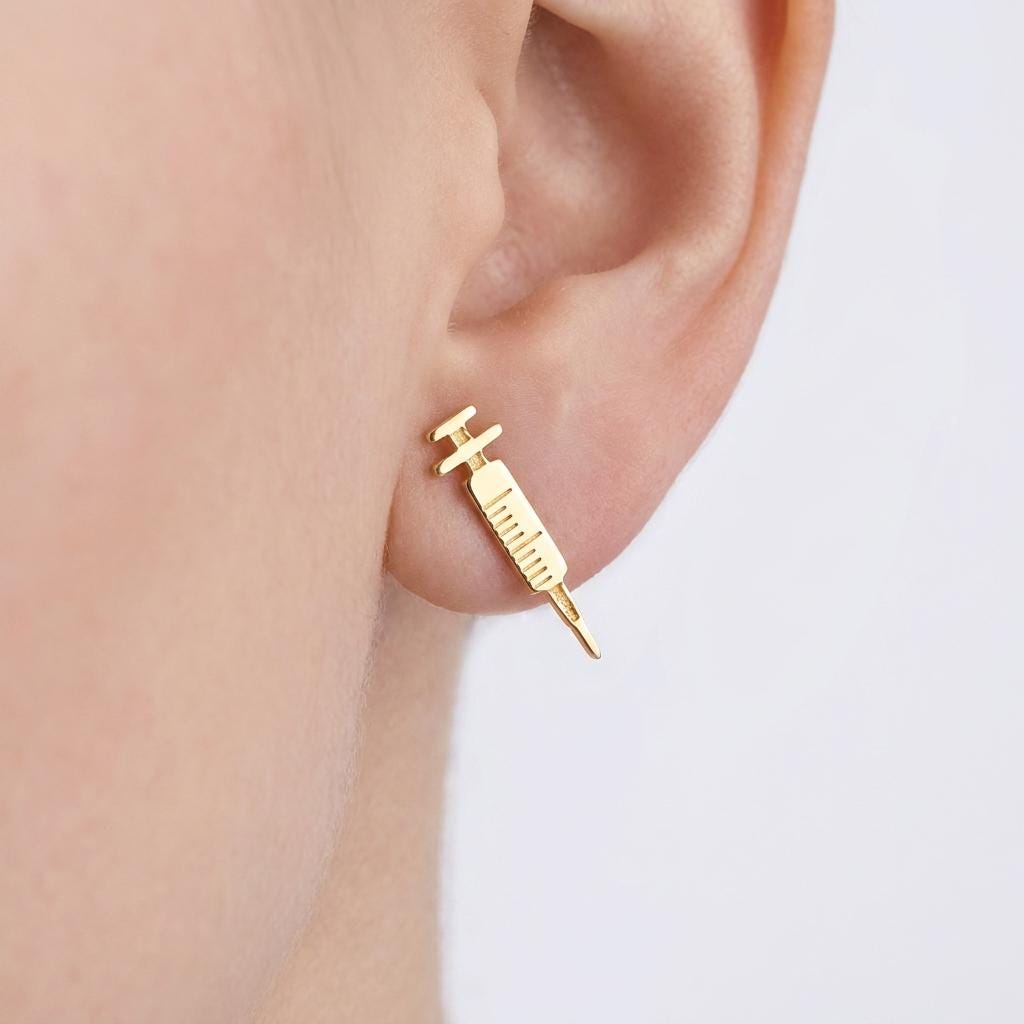 Pair of long thin gold syringe stud earrings with barrel and needle detail (2 of 9)