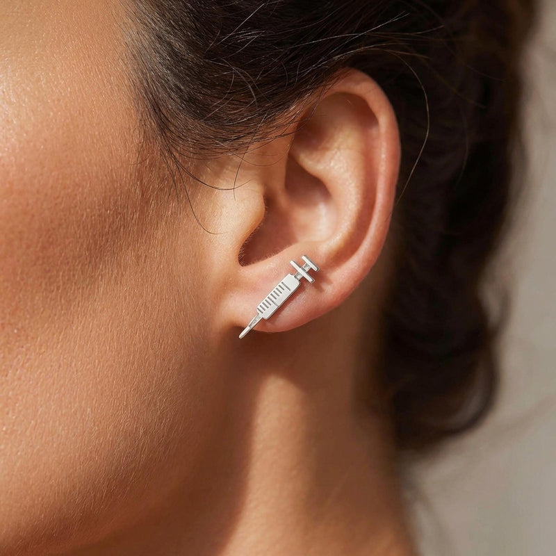 Pair of long thin gold syringe stud earrings with barrel and needle detail (3 of 9)