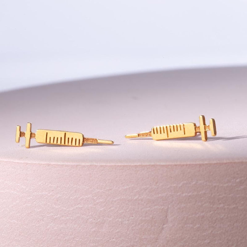 Pair of long thin gold syringe stud earrings with barrel and needle detail (6 of 9)