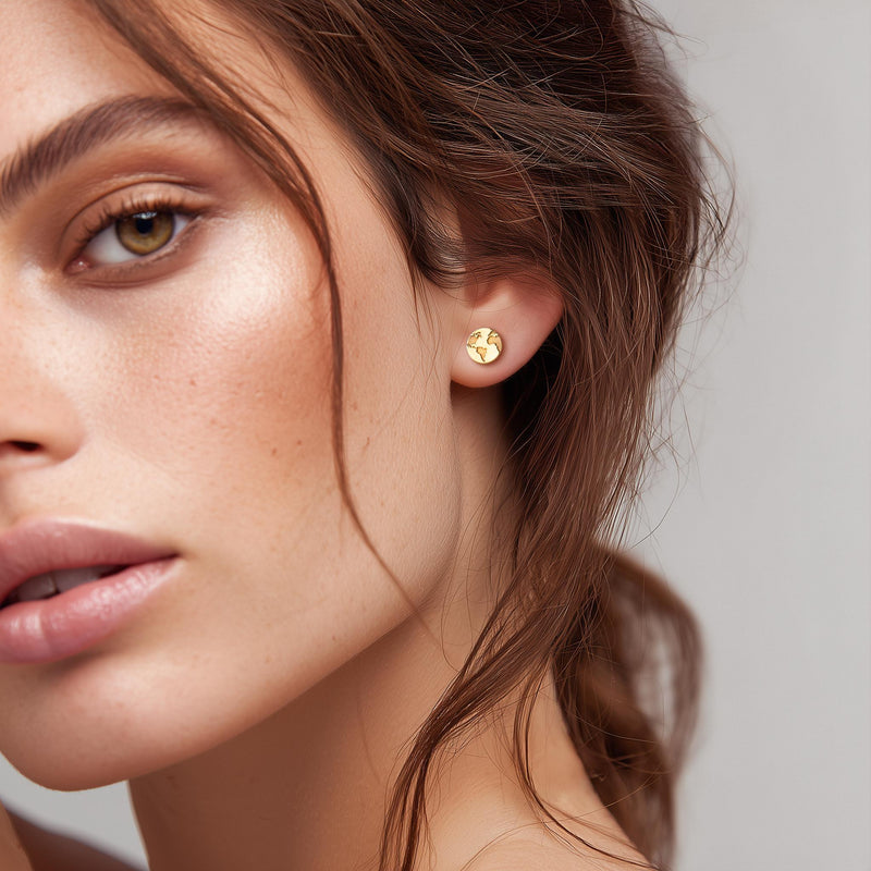 Pair of tiny round gold globe stud earrings with meridian lines, on white (4 of 12)