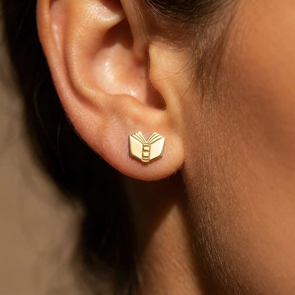 Pair of small gold open book stud earrings with split pages