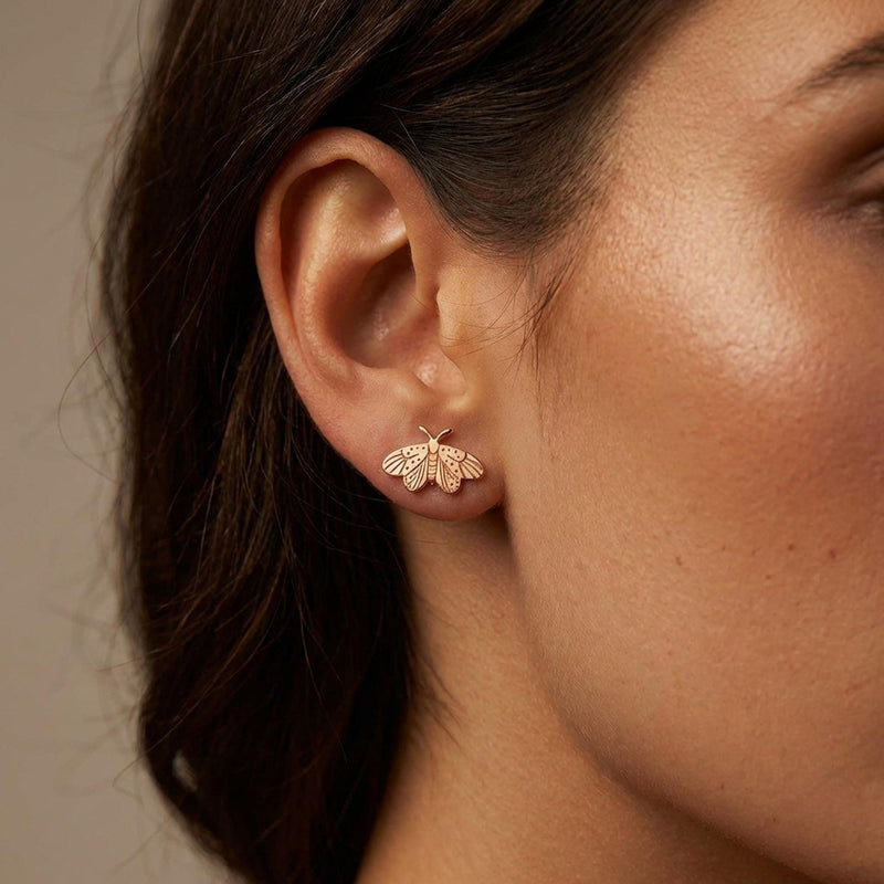 Small gold moth stud earrings with broad wings and feathered antennae (8 of 12)