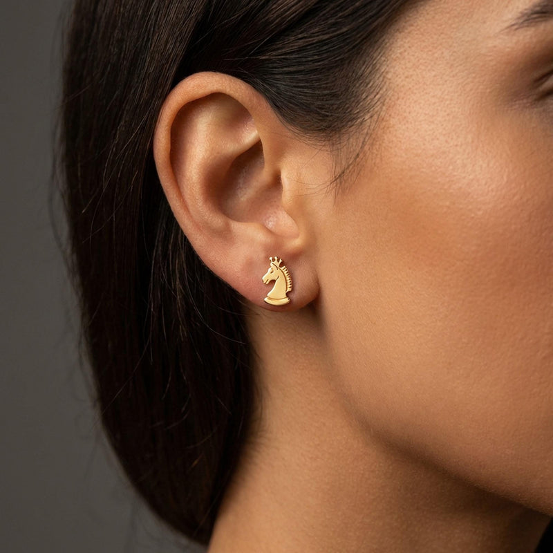 Set of gold chess piece stud earrings including knight, king and pawn, white background. (3 of 9)
