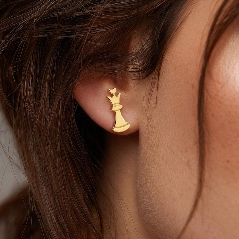 Set of gold chess piece stud earrings including knight, king and pawn, white background. (5 of 9)