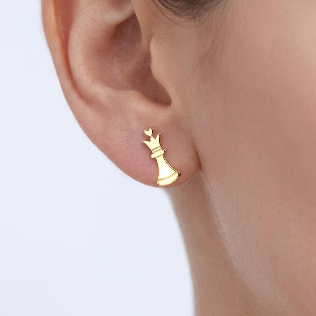Pair of gold chess piece stud earrings shown in side profile
