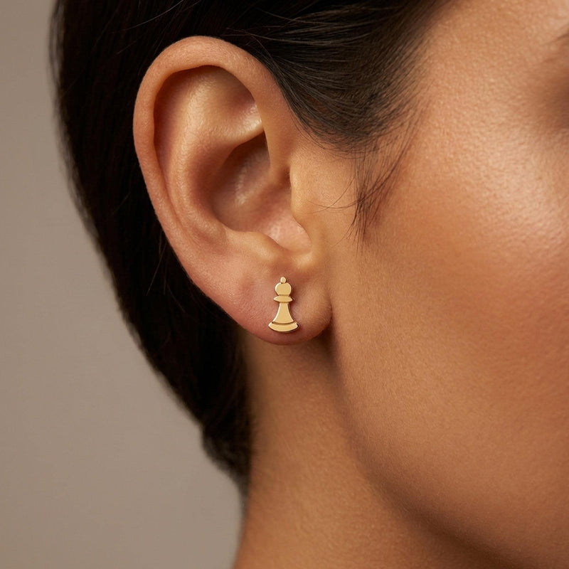 Pair of gold chess piece stud earrings shown in side profile (8 of 9)