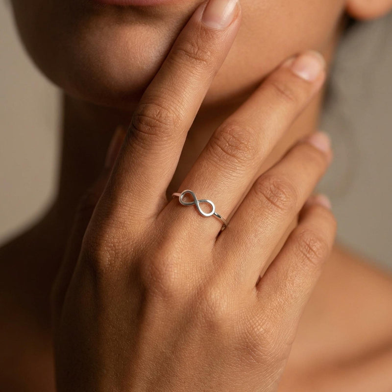 Thin gold infinity ring with a flat crossed loop on the band (7 of 10)