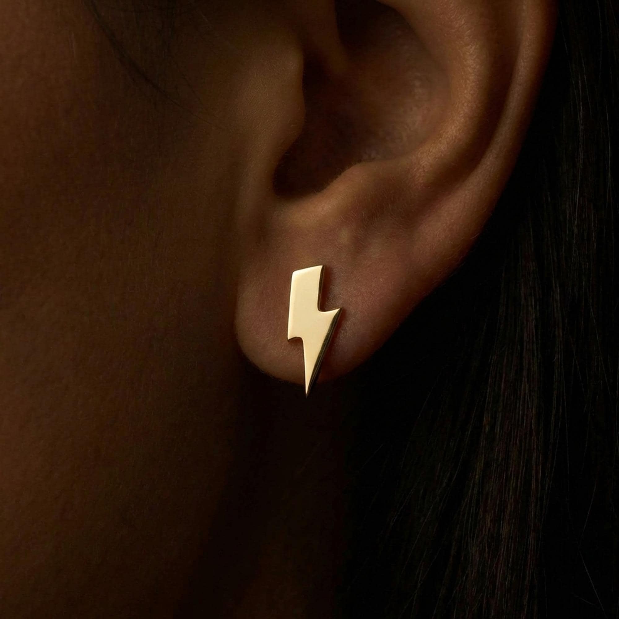 Pair of small gold lightning bolt stud earrings with sharp angled points. (2 of 12)