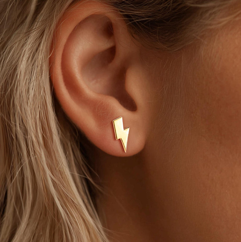 Pair of small gold lightning bolt stud earrings with sharp angled points. (3 of 12)