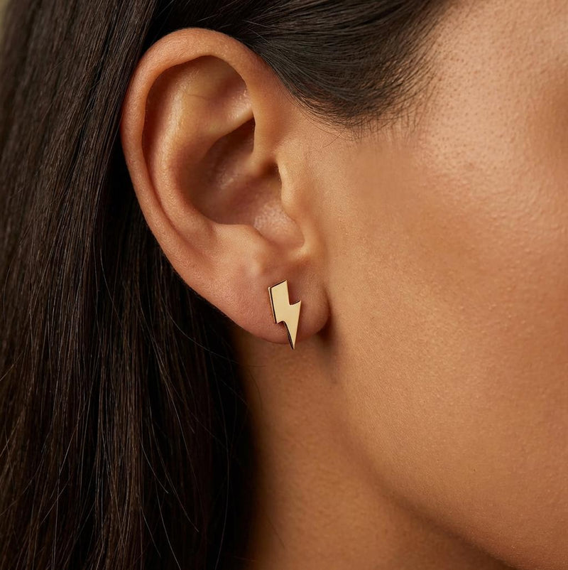 Pair of small gold lightning bolt stud earrings with sharp angled points. (5 of 12)