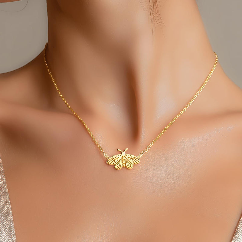 Fine gold chain necklace with a small moth pendant with open wings and antennae (3 of 10)