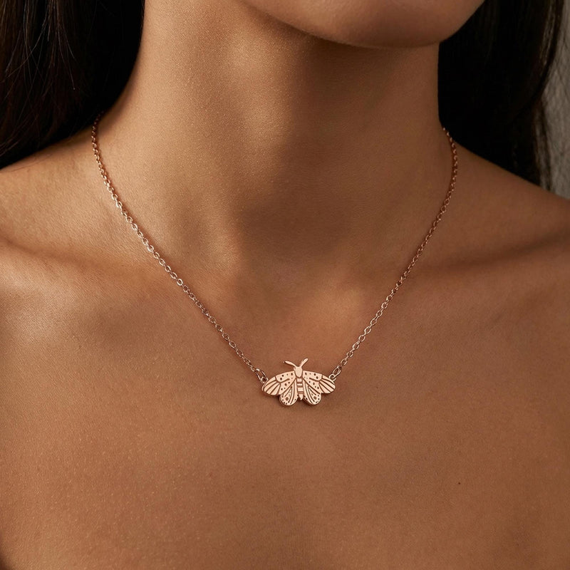 Fine gold chain necklace with a small moth pendant with open wings and antennae (4 of 10)