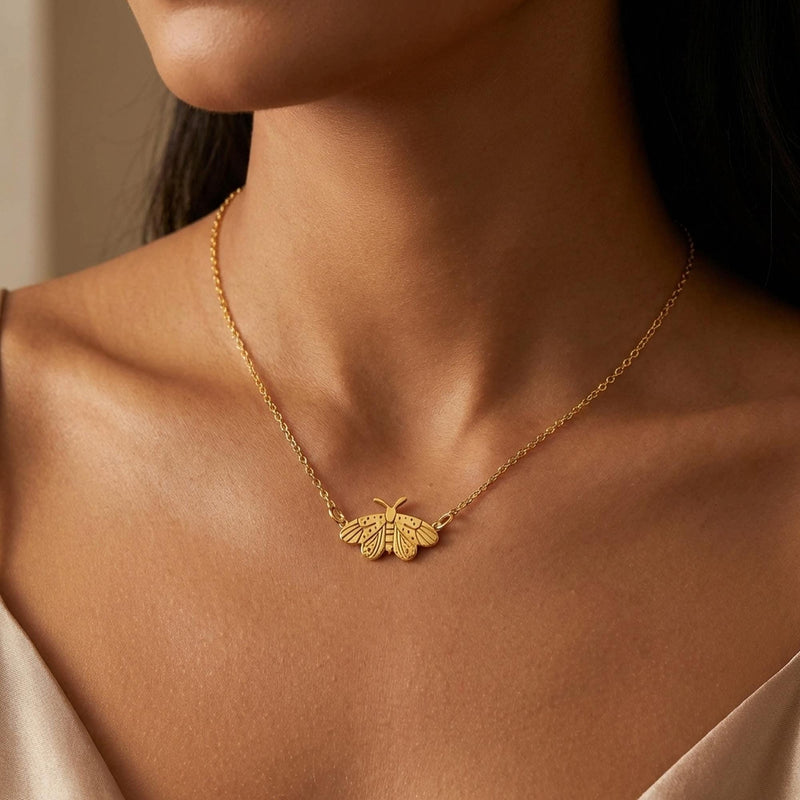 Fine gold chain necklace with a small moth pendant with open wings and antennae (5 of 10)