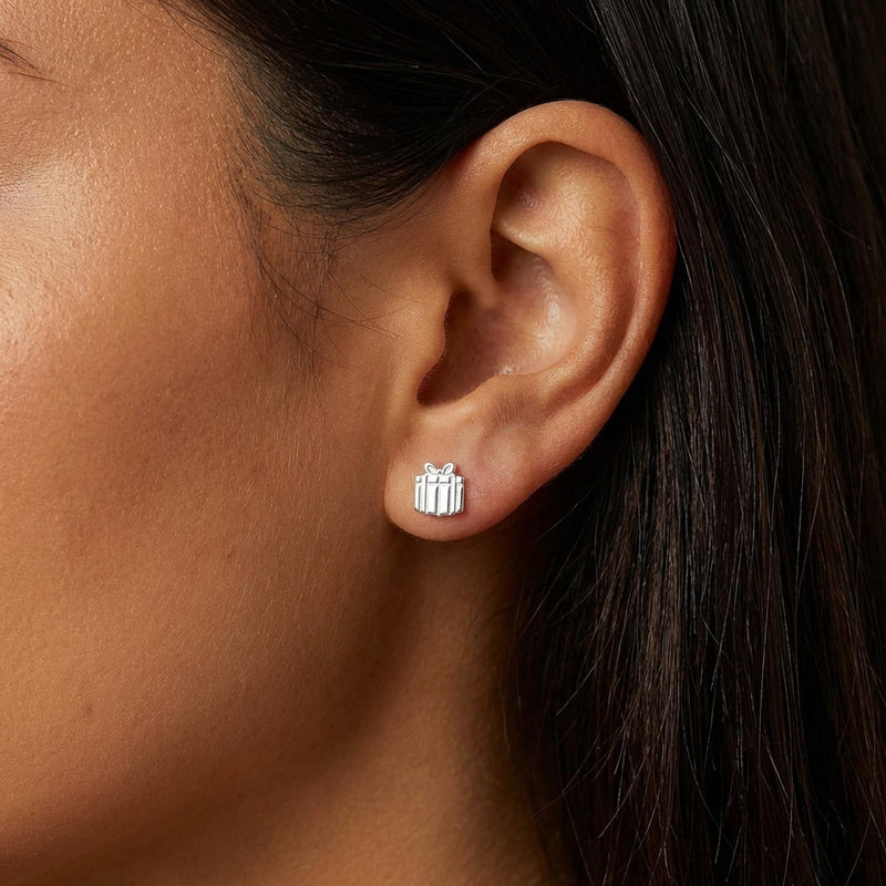Pair of tiny gold present stud earrings with a ribbon across the front and a bow on top (10 of 11)