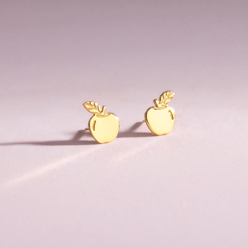 Pair of tiny gold apple stud earrings with stem and leaf, shown on white (6 of 10)