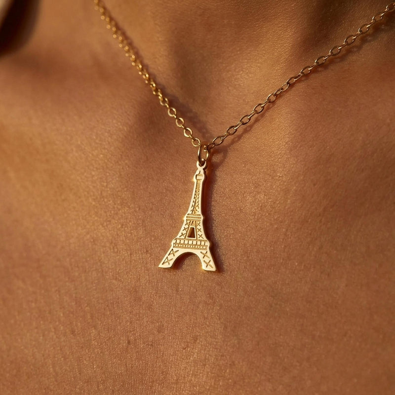 Narrow gold Eiffel Tower pendant with open lattice on a fine chain.
