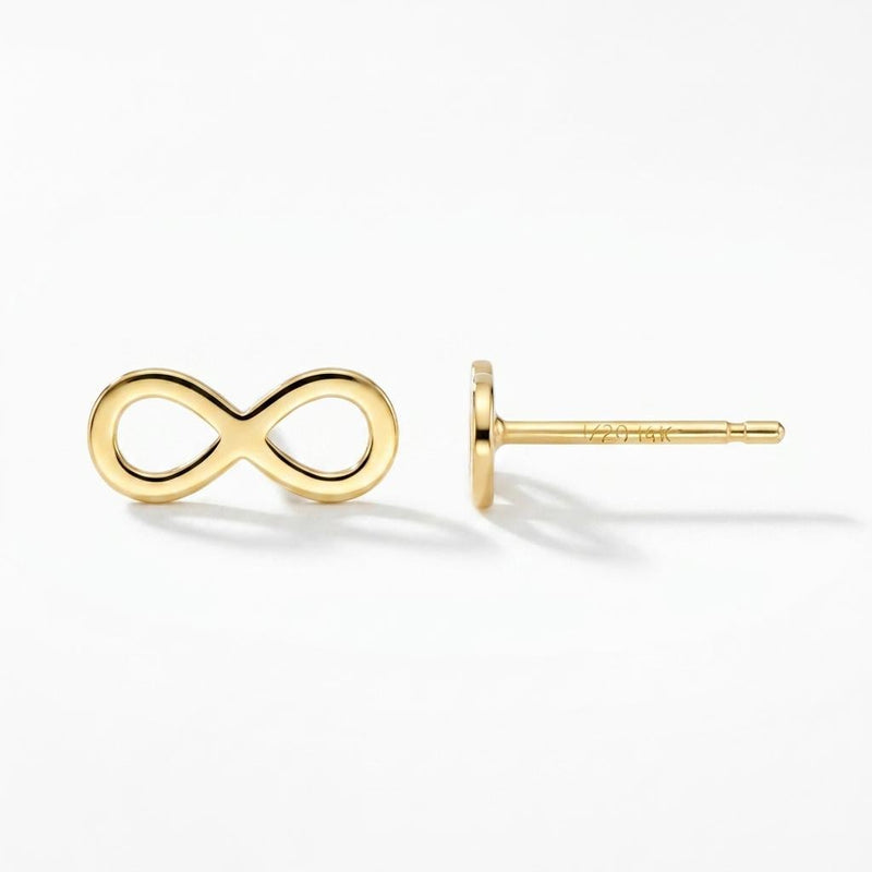 Pair of slim gold infinity symbol stud earrings on a white background.