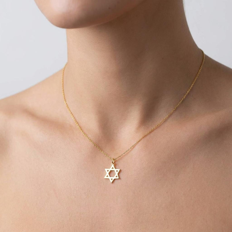 Small Star of David pendant in gold on a fine cable chain, shown on a plain background.