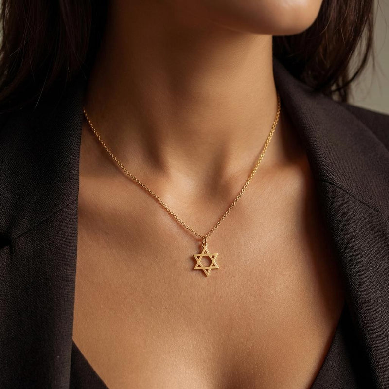 Small Star of David pendant in gold on a fine cable chain, shown on a plain background. (4 of 8)