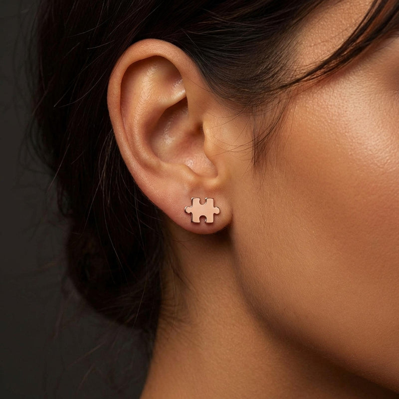 Pair of small gold puzzle piece stud earrings with a tab and notch (7 of 7)