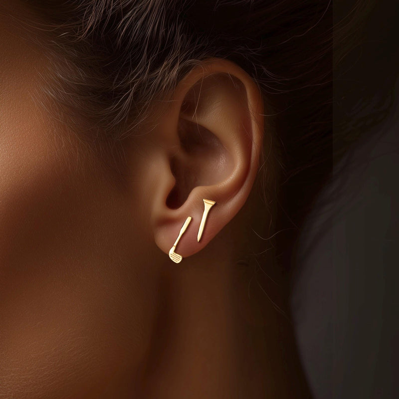 Pair of narrow gold golf tee stud earrings standing upright, front view. (3 of 10)