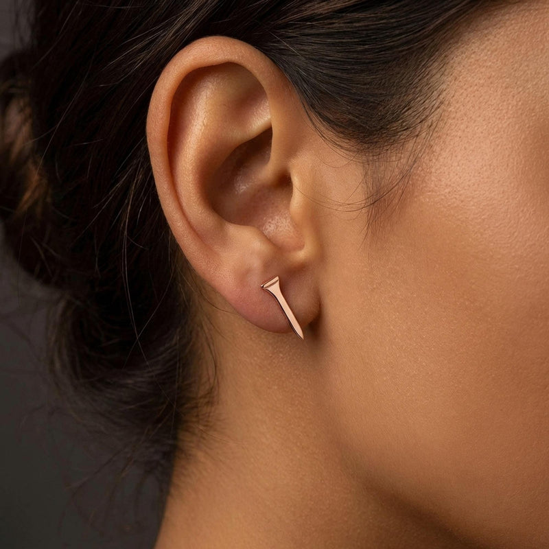 Pair of narrow gold golf tee stud earrings standing upright, front view. (6 of 10)