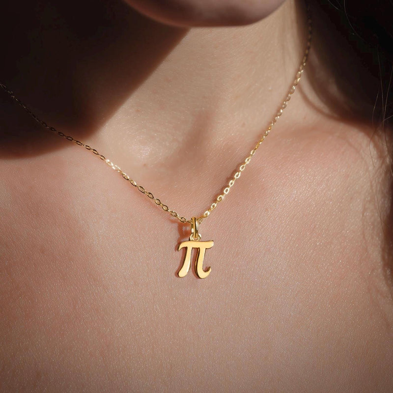 Small gold pi symbol pendant hanging from a fine cable chain (2 of 10)