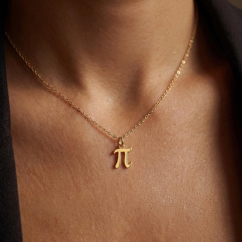 Small gold pi symbol pendant hanging from a fine cable chain (3 of 10)