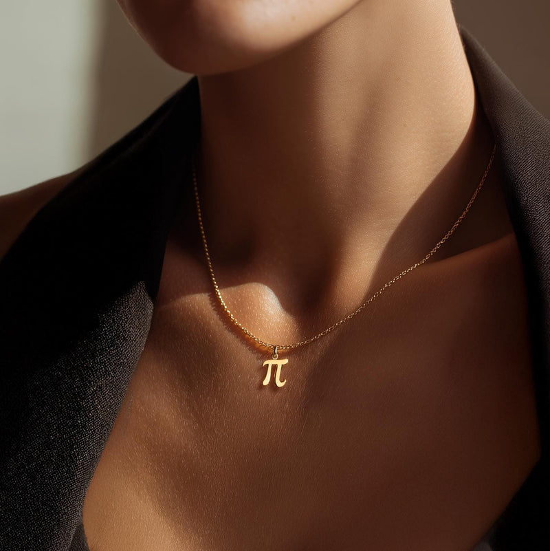Small gold pi symbol pendant hanging from a fine cable chain (6 of 10)
