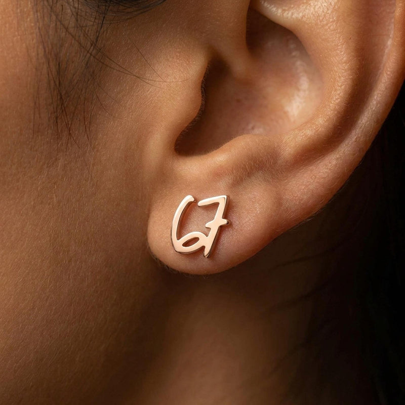 Pair of gold number stud earrings, one reading six and one reading seven (4 of 11)