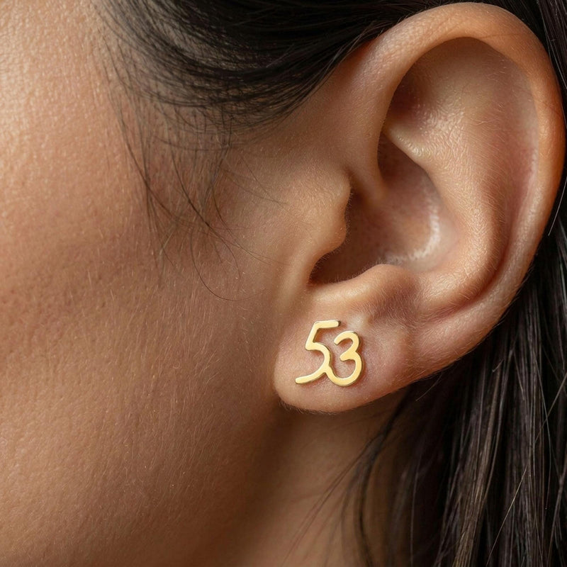 Pair of gold number stud earrings, one reading six and one reading seven (5 of 11)