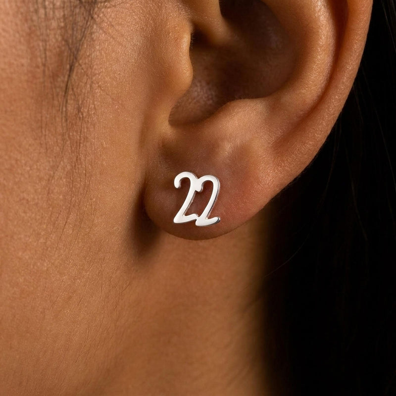 Pair of gold number stud earrings, one reading six and one reading seven (6 of 11)