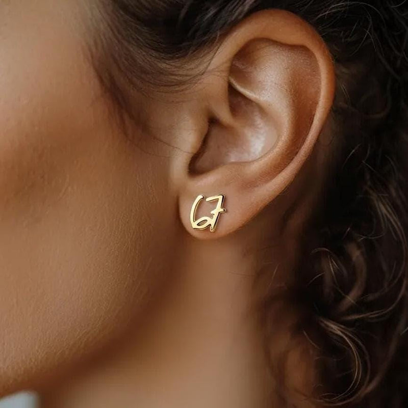 Pair of gold number stud earrings, one reading six and one reading seven (9 of 11)
