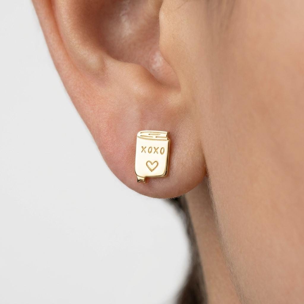Pair of small gold XOXO letter stud earrings in a handwritten style (2 of 7)
