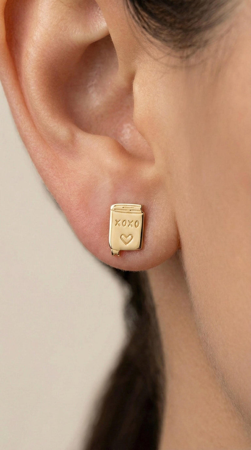 Pair of small gold XOXO letter stud earrings in a handwritten style (4 of 7)